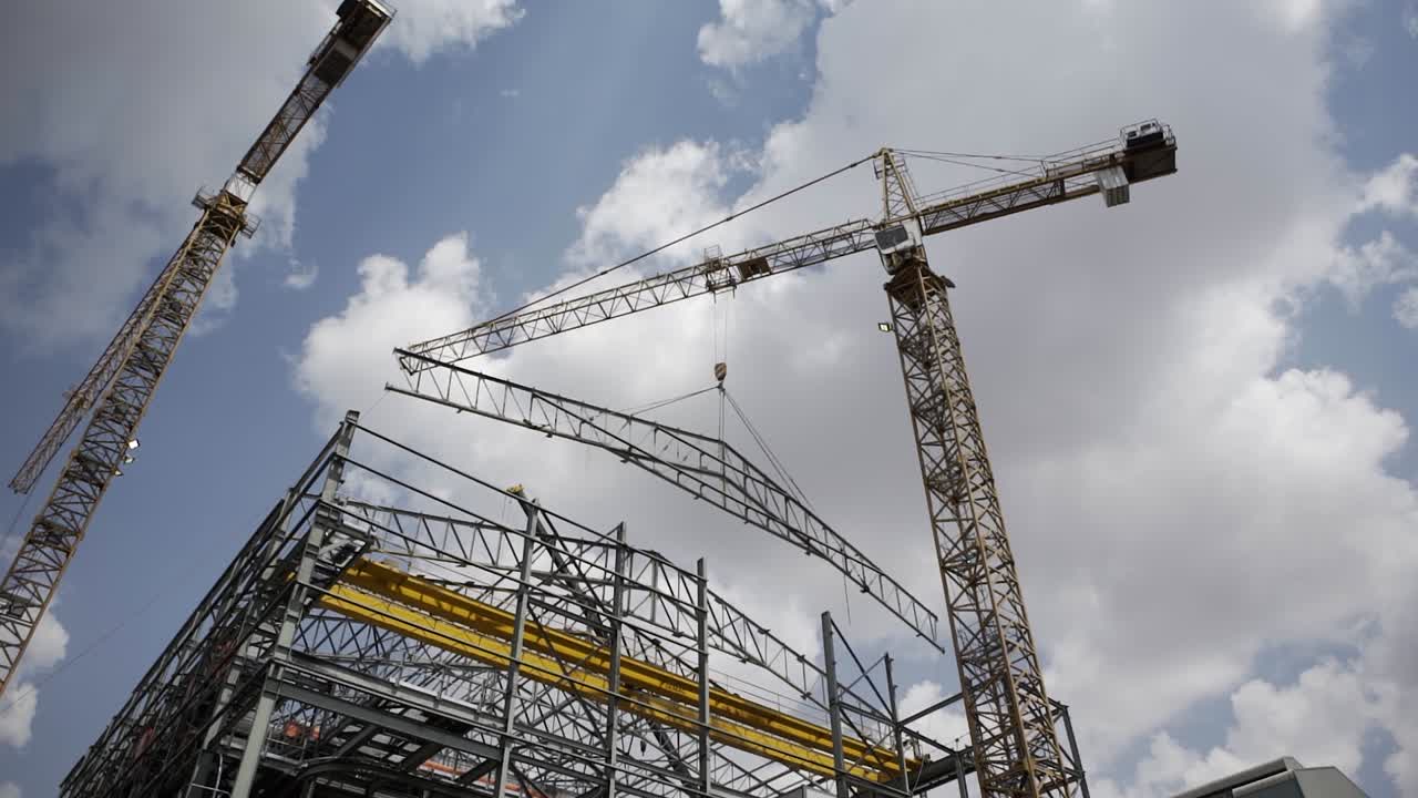 Towering above, a high crane stands sentinel at a construction site, emblematic of human ambition and the intricate ballet of urban development and engineering prowess