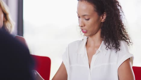 Professional-businessman-talking-to-his-colleagues-while-sitting-in-modern-office-in-slow-motion