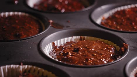 choco oat cake mixture in a mold lined with baking paper ready for baking