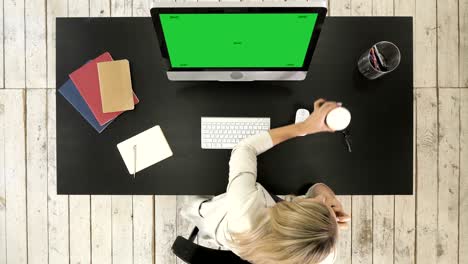 woman working on computer and talking on the phone. green screen mock-up display