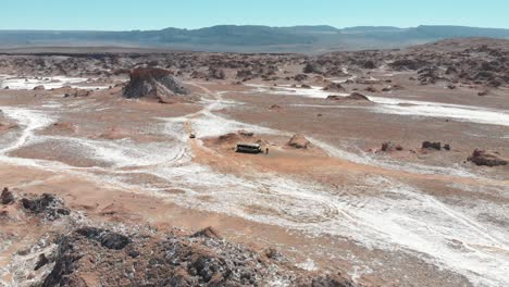 aerial drone shot distancing of an abandoned bus in atacama desert, south america, chile