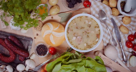 Soup-In-Bowl-Amidst-Various-Ingredients-Assorted-On-Wooden-Table-1