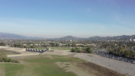 Panning-alongside-the-Sepulveda-Dam-and-San-Fernando-Valley-freeway-during-rush-hour