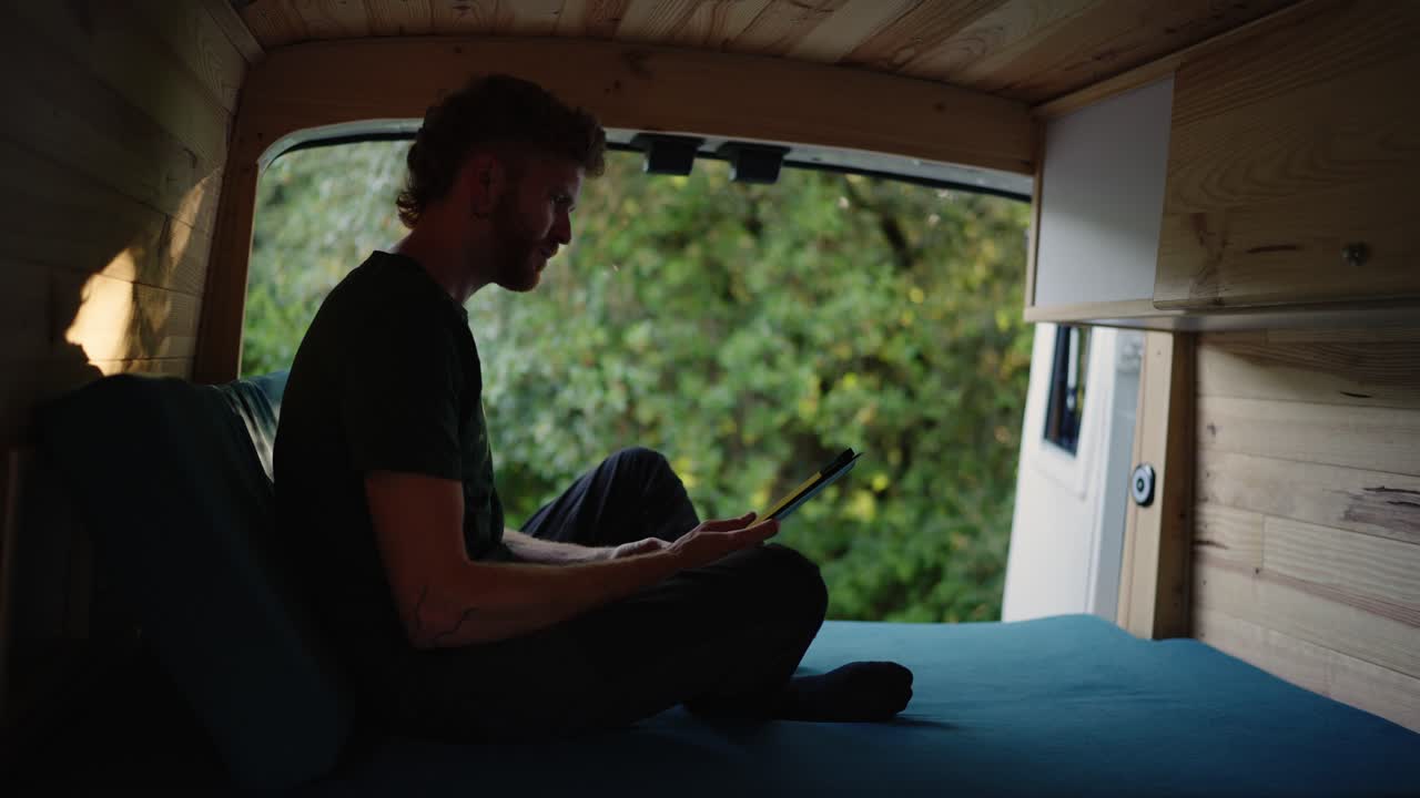 Man using tablet in camper van