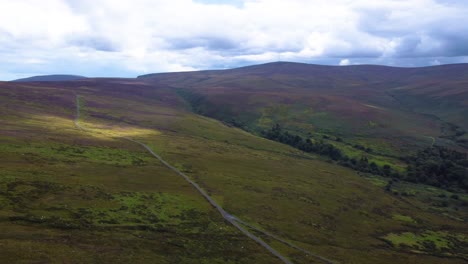 aerial orbiting shot of dramatic irish highlands and mountains