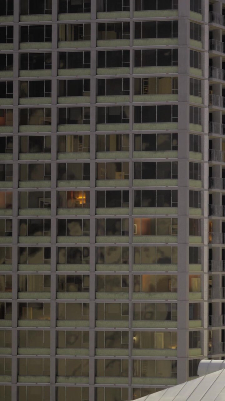 Edifici con le luci accese di sera in una città.