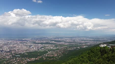 aerial shot, revealing the city of sofia, bulgaria, from high up in a mountain, on a sunny spring day, shot from vitosha mountain