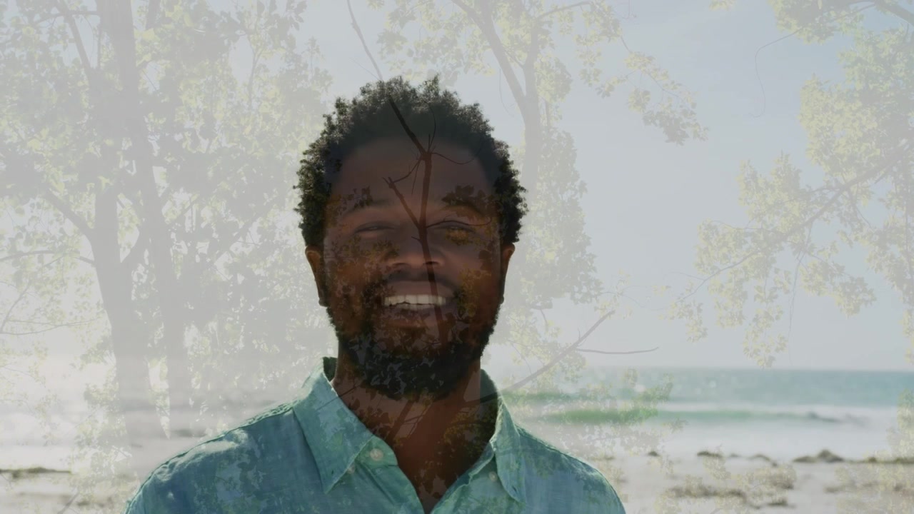 Animation of tree over african american man smiling