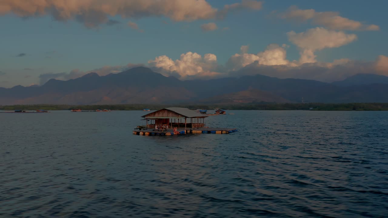 Floating bar in west Bali during tropical sunset, travel destination, aerial
