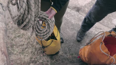 person taking out a rope from a bag