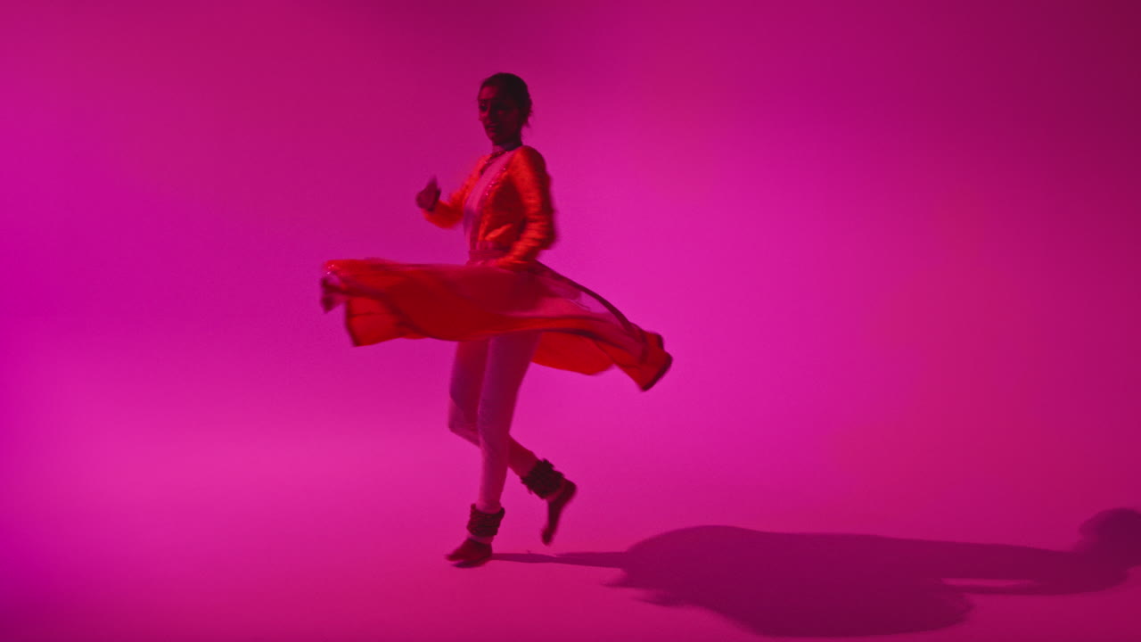 Full Length Studio Shot Of Female Kathak Dancer Performing Dance Wearing Traditional Indian Dress Against Purple Background 1
