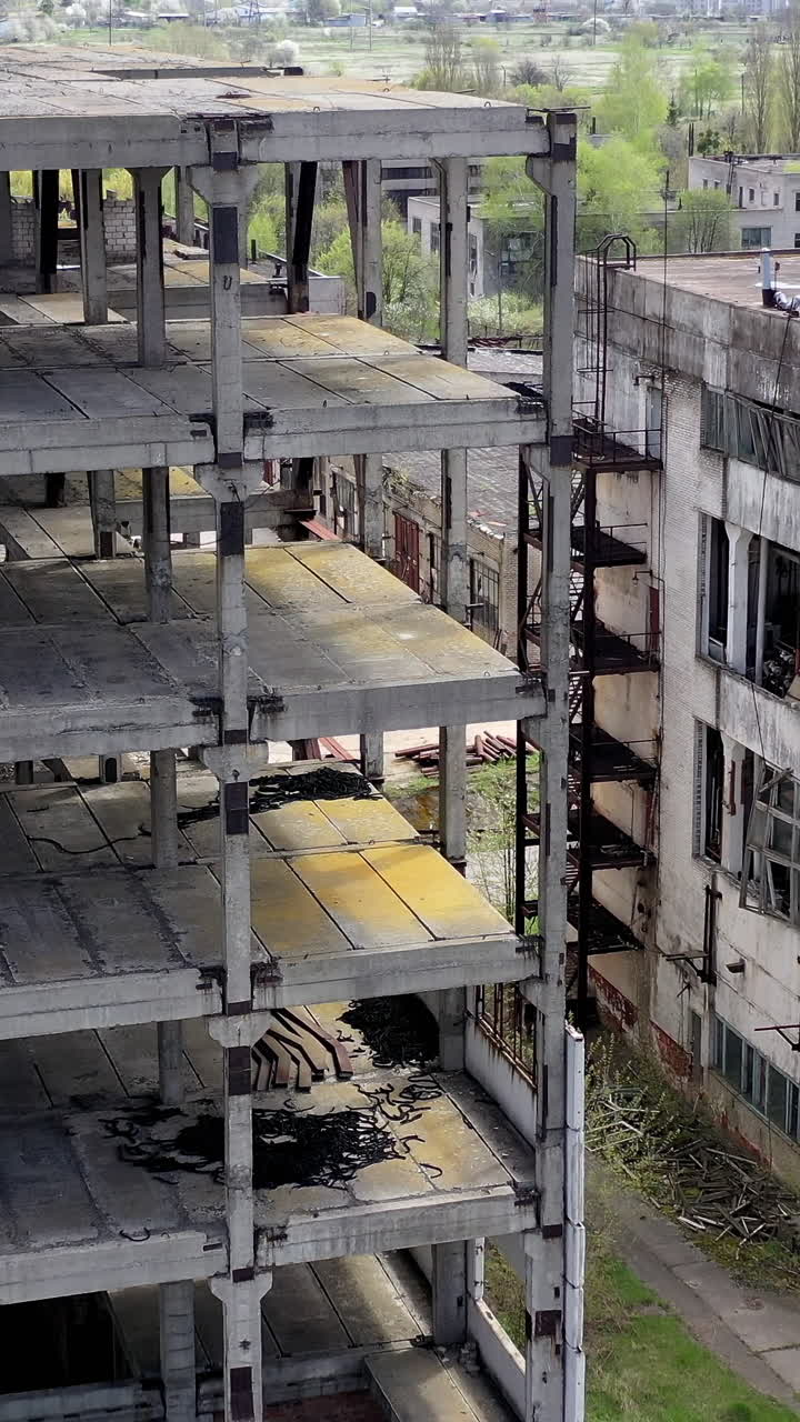 Old industrial buildings. Ruined factory buildings of industry. Empty abandoned place. Aged industrial edifices. Vertical video