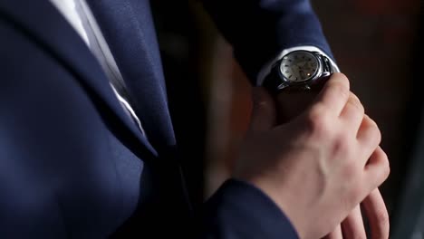 man checking time in a suit