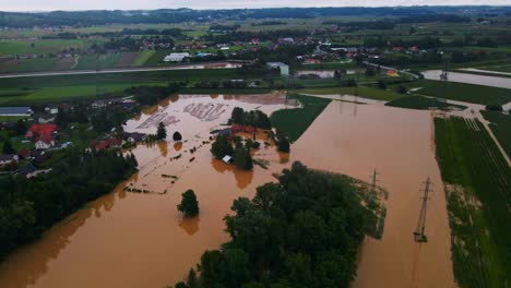 Horrific-Aerial-4K-Drone-footage-of-houses-in-Podravje,-Slovenia,-during-August-floods