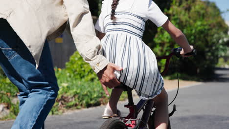 man, girl and bicycle for learning to ride