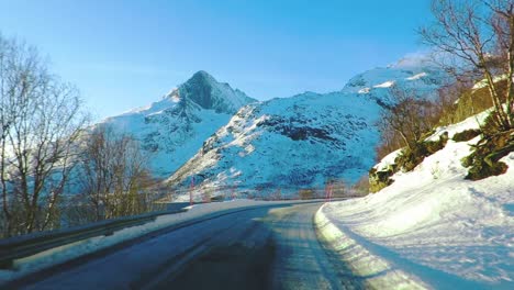 Mountain-road-covered-in-snow-in-a-northern-country-in-winter-filmed-from-a-moving-car