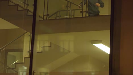 person running up stairs in building at night