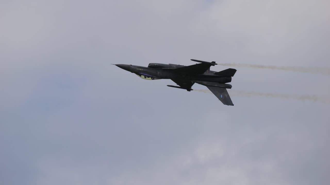 Fighter plane flies upside down through the air and shoots flares. Taken at Airpower 2024