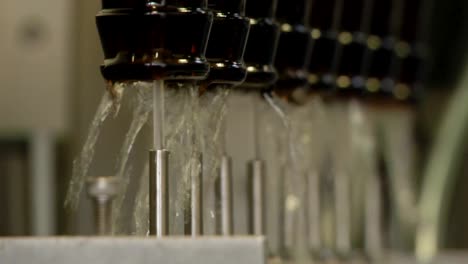 Beer-bottles-being-washed-upside-down-with-jets-of-water-before-the-bottling-process