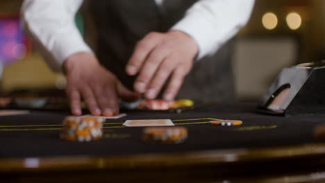 croupier dealing cards at the poker table.