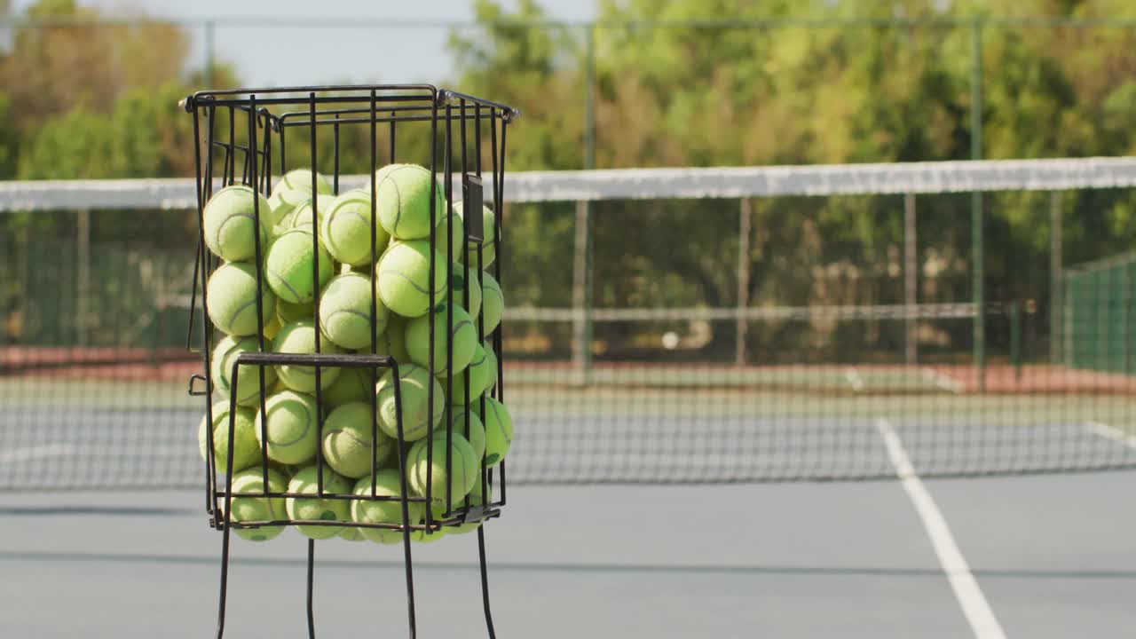 Video of basket with tennis balls on tennis court
