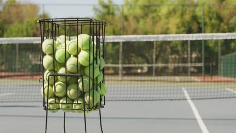 video of basket with tennis balls on tennis court