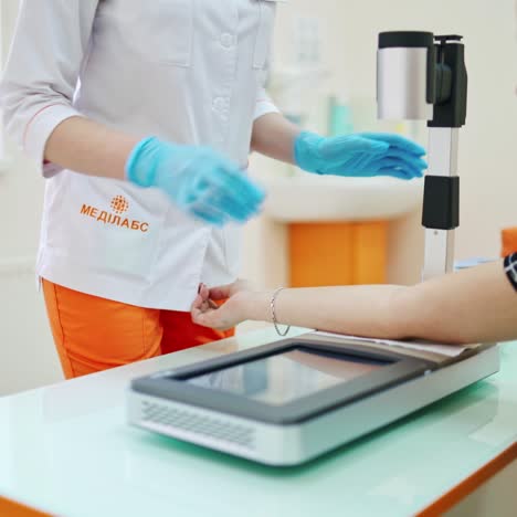 nurse taking blood in clinic