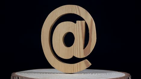 real wooden mail symbol rotates on black background