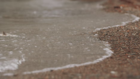 Waves-in-slow-motion-hitting-the-rocky-shore-and-crashing-with-power