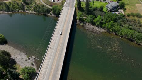 top down view of a car driving over a bridge that crosses the spokane river