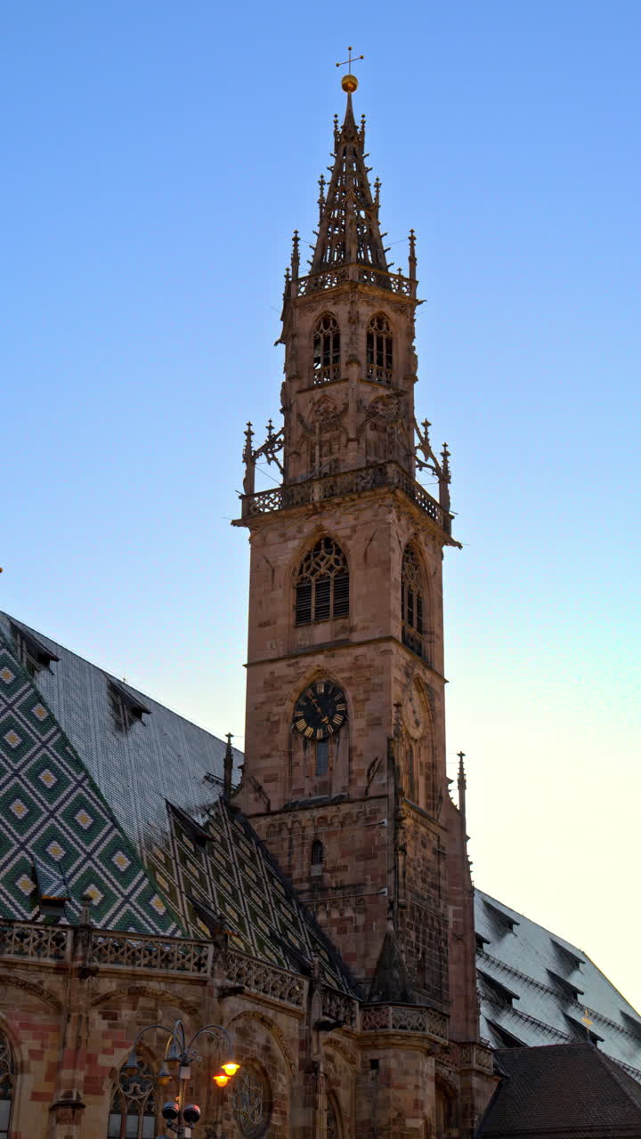 View of the cathedral Maria Himmelfahrt of Bolzano, the Dolomites, Italy in the evening. Vertical