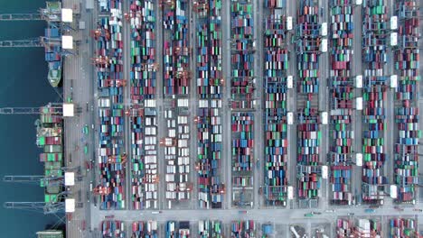 mega container ship docked at hong kong port, during loading and unloading operation, aerial view