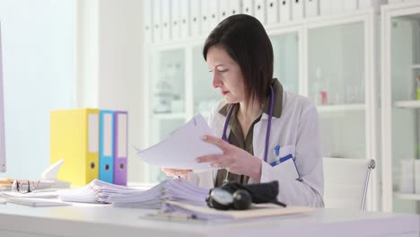 Female Doctor Reviewing Documents in Her Office