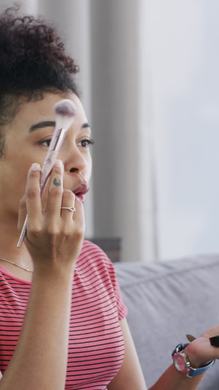 Young Woman Applying Makeup with a Brush