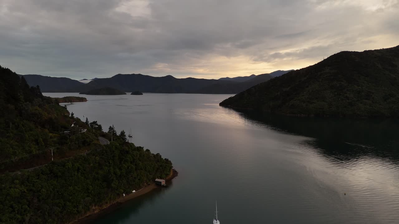 Marlborough Sounds and coastal road at sunrise, New Zealand. Aerial drone