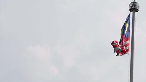 waving malaysian flag against the sky