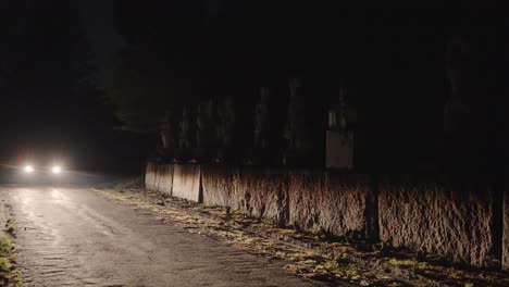 car driving around lonely dark mountain road at night