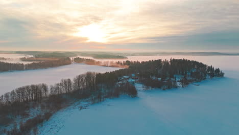 Ascending-to-show-vast-nordic-scandinavian-landscape-with-forest-covered-in-snow-and-ice-and-fog-engulfing-the-beatiful-scenery