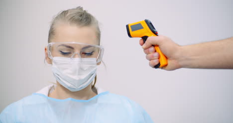 doctor measuring patient temperature at health care clinic 8