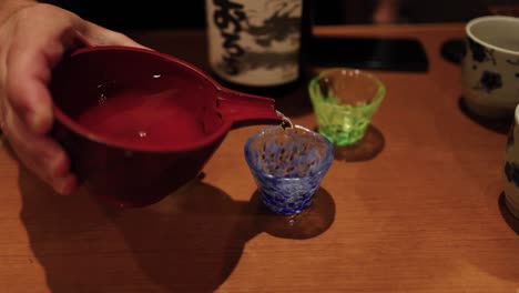 sequence of pouring a drink into colorful cups