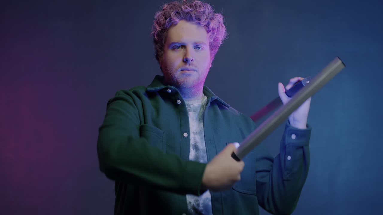 Man Posing with Neon Light Sticks