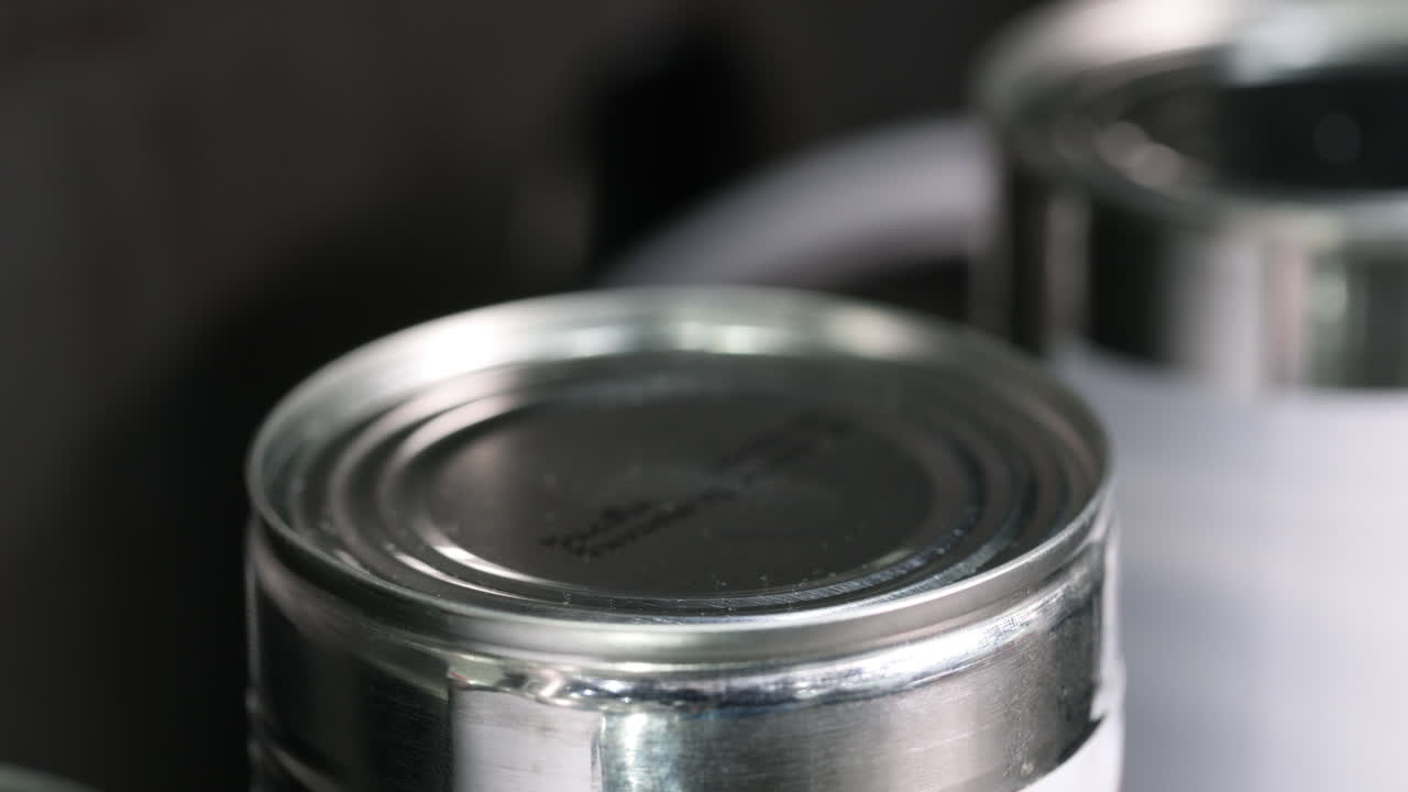 Close-up of Metal Can Being Stamped on Production Line