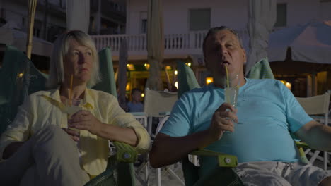 senior adult man and woman drinking cocktails