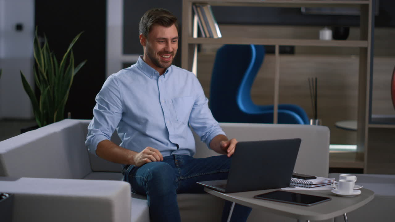 Happy businessman video chatting