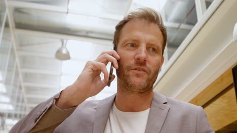 Businessman-talking-on-mobile-phone-in-office-4k