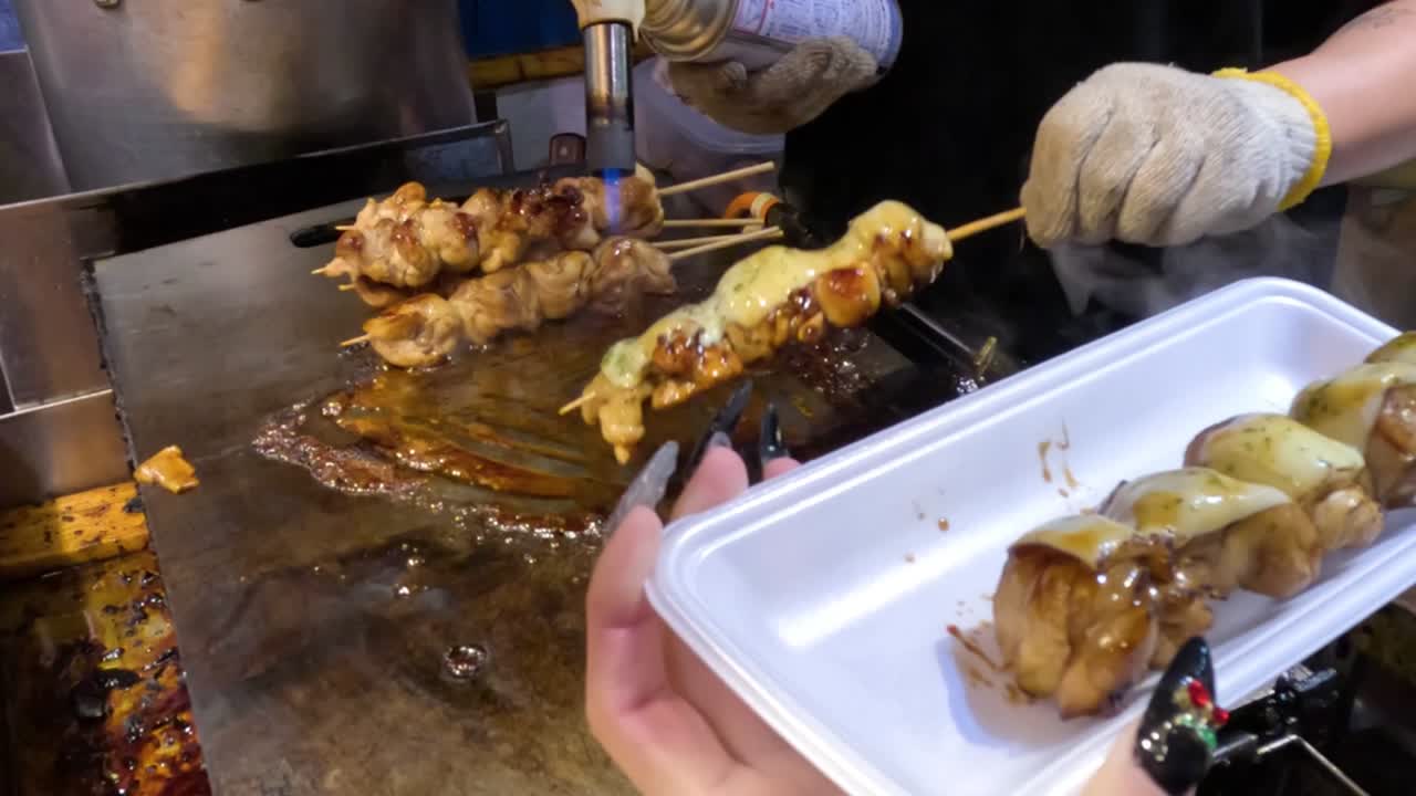 Preparing Delicious Chicken Skewers at a Street Food Stall