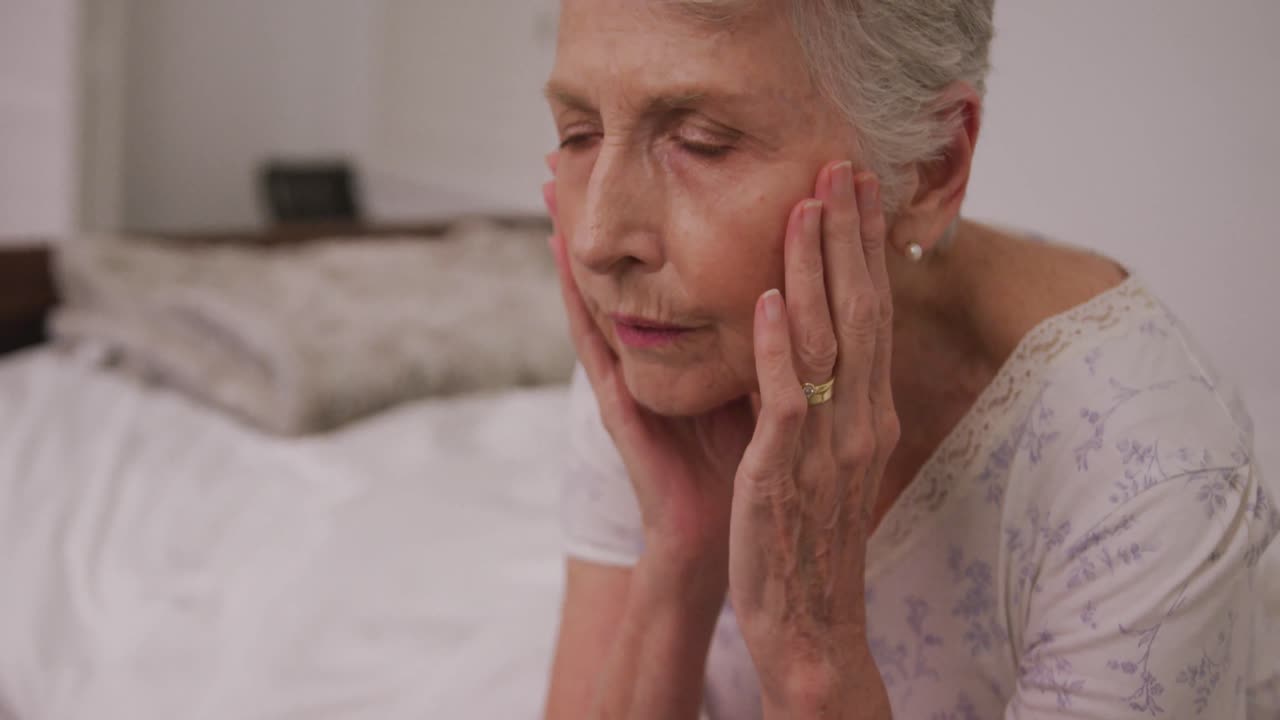 mujer caucásica mayor que parece cansada en casa