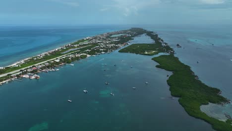 Aerial-view-of-sailboats-on-the-coast-of-Isla-Mujeres,-Mexico---reverse,-drone-shot