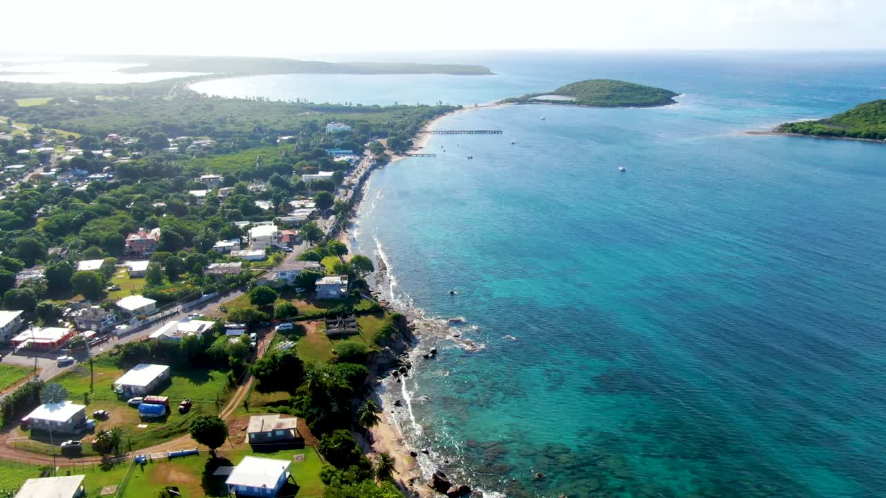 Aerial of the Esperanza neighborhood and tropical ocean with islands Cayo Real and Cayo de Tierra in the distance
