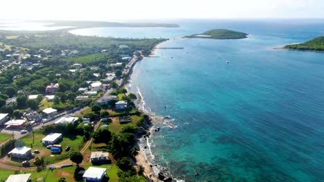aerial of the esperanza neighborhood and tropical ocean with islands cayo real and cayo de tierra in the distance